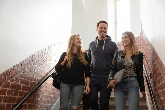 Tre studenter går ner för trappan.