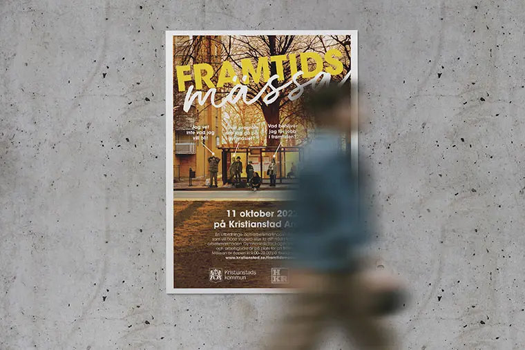 Person går förbi betongvägg med Framtidsveckanposter.