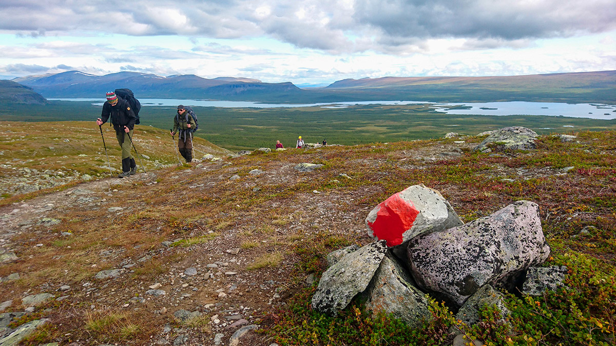 &Aring;tta studenter och tre l&auml;rare p&aring; v&auml;g mot Skierffe och utsikten &ouml;ver Rapadalen. I bakgrunden syns l&aring;ngstr&auml;ckta &Aacute;vtsusjv&aacute;gge, d&auml;r namnet och &auml;ndelsen v&aacute;gge f&ouml;rklarar att det handlar om en U-formad dalg&aring;ng, varifr&aring;n vandringen g&aring;tt l&auml;ngs Kungsleden fr&aring;n fj&auml;llstationen i Saltoluokta. Foto: Fabian Rimfors