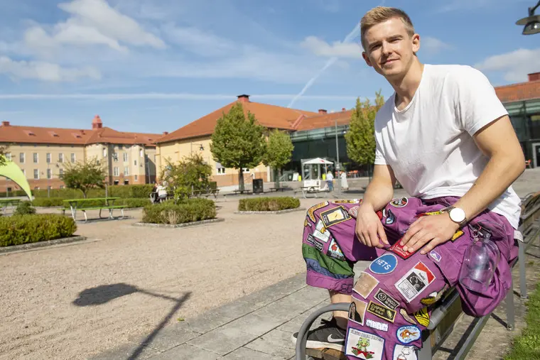 Student som sitter på bänk.