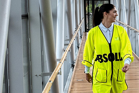 Sofia Hörlin gåendes på sin arbetsplats, klädd i gul väst.