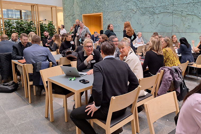 Groups of people sitting around tables.